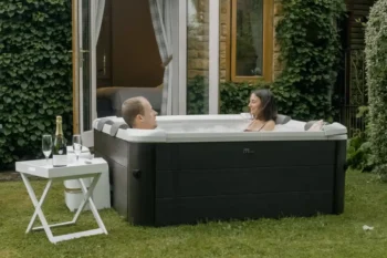 A couple enjoying the comfort and convenience of MSpa Tribeca in their garden.
