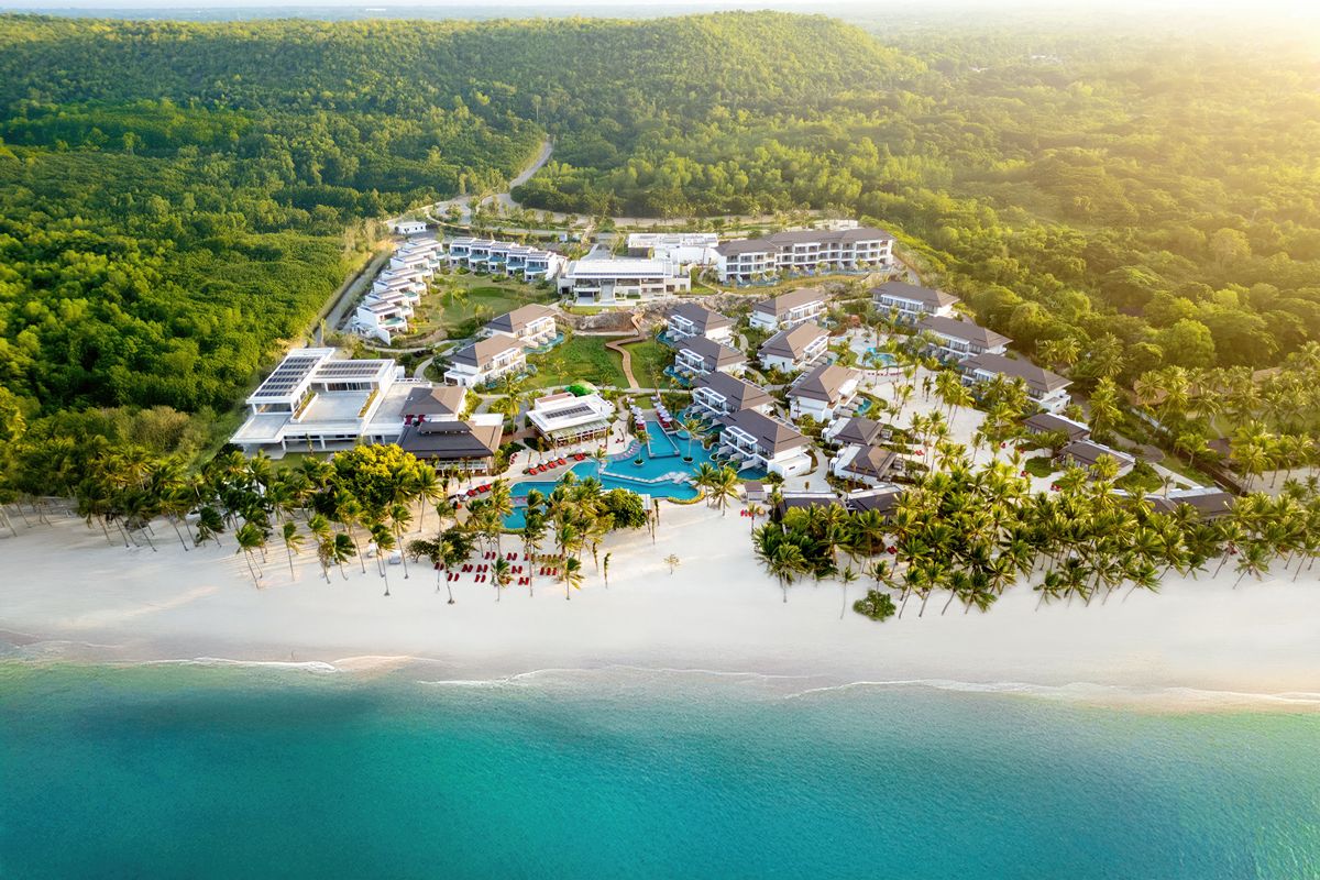 Aerial view of South Palm Resort by M Gallery in Bohol showcasing beachfront villas, turquoise waters, and tropical surroundings.